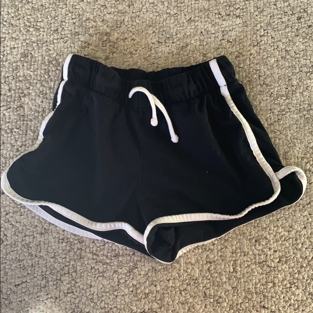 Black shorts with white stripes.